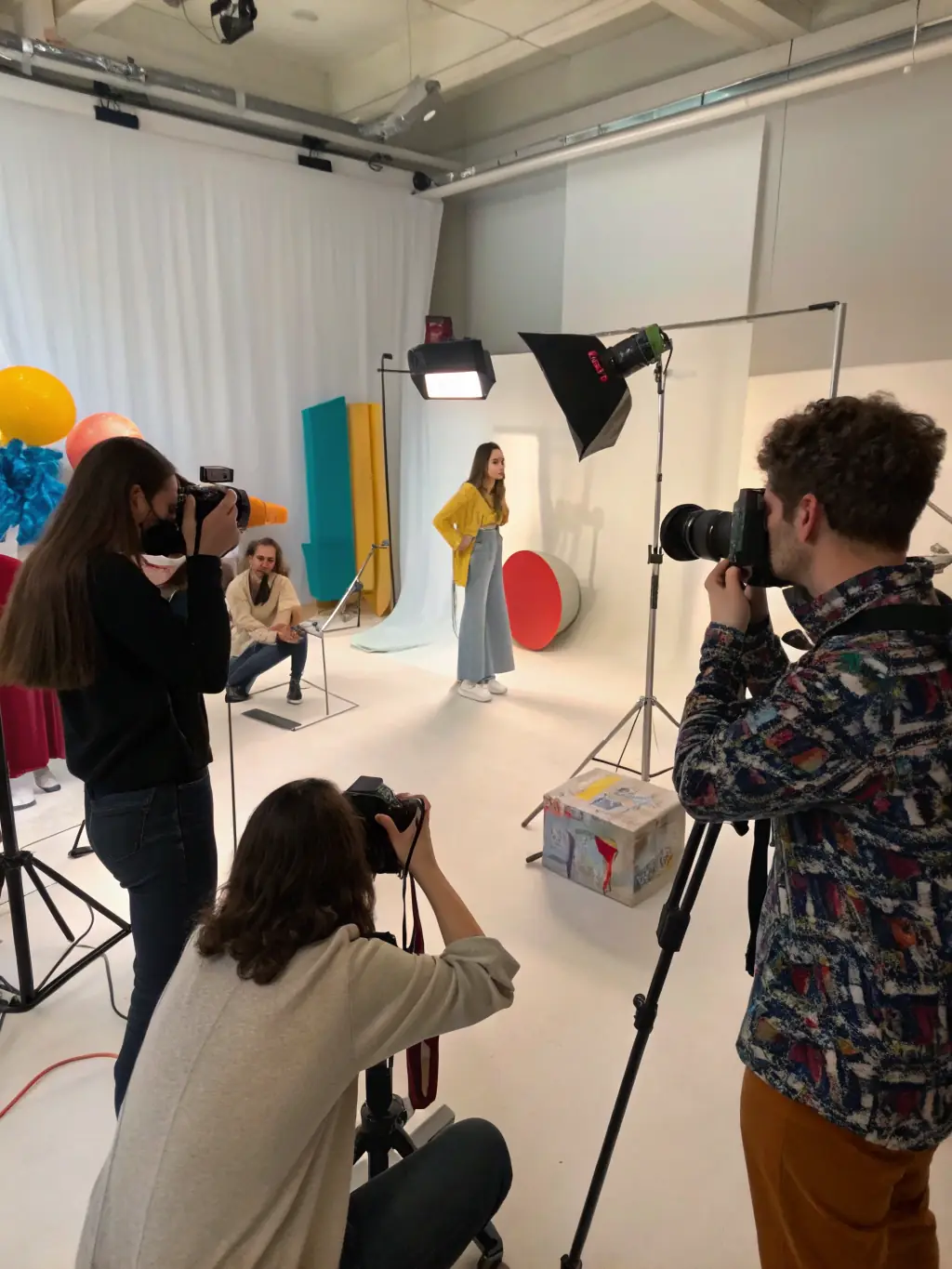 An image of a youth photography workshop facilitated by CULTURE - EVOLUTION, showing young participants learning photography skills and capturing their community's stories.